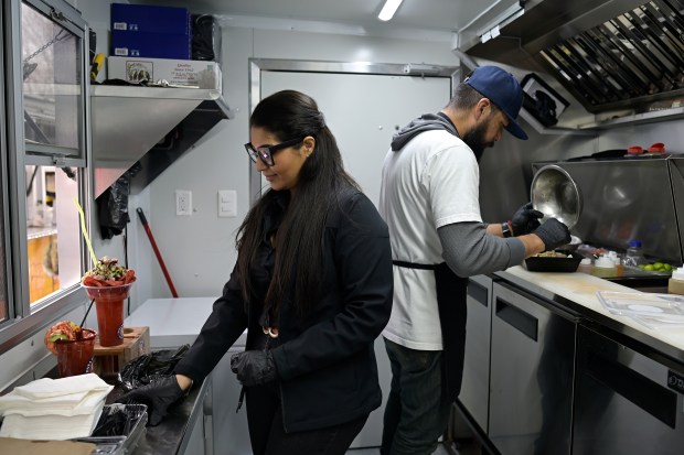 Patsy Aguilar, left, and her husband Ramon Lizarraga prepare food on their Pata Salada Ceviches food truck at La Plaza Colorado in Aurora on Friday, March 7, 2025. (Photo by Hyoung Chang/The Denver Post)